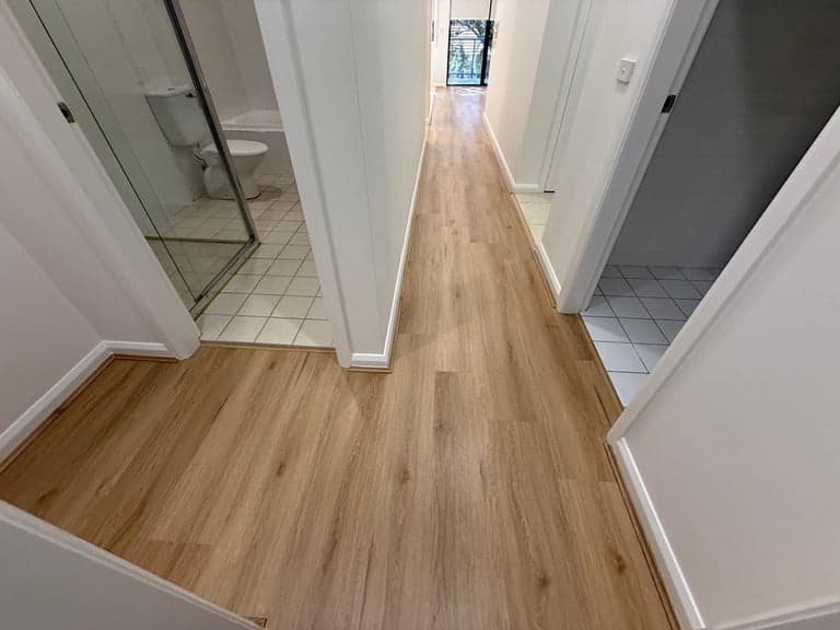 Light oak hallway flooring in Sydney looking toward a tiled bathroom