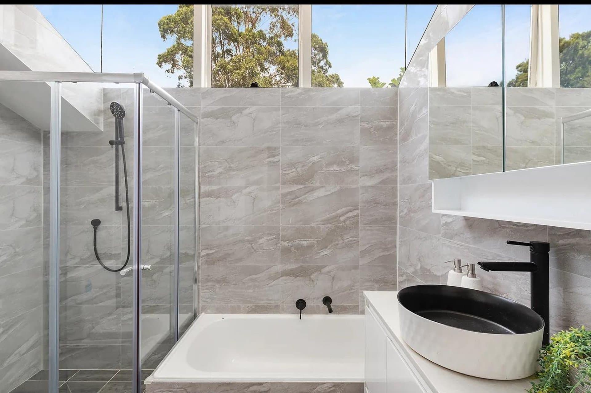 Sydney bathroom renovation with a stone bath and glass shower